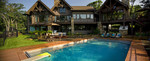 Large Backyard luxury pool overlooking lake-hot tub-wrought iron fence- terracotta deck-outdoor dining