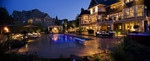 dusk pool-outdoor kitchen-large outdoor fireplace-landscape lighting-whirpool-